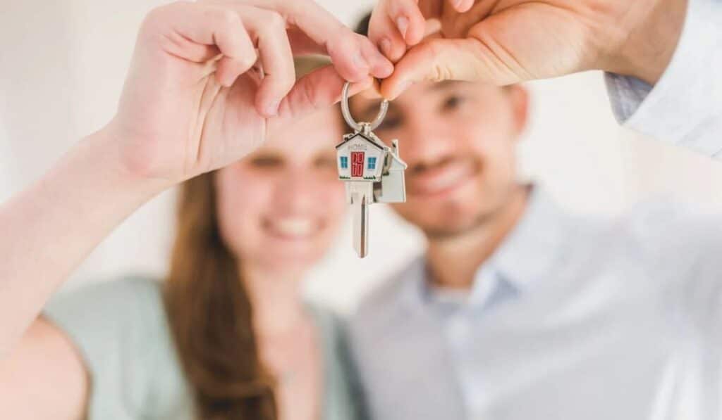 happy couple holding a house key