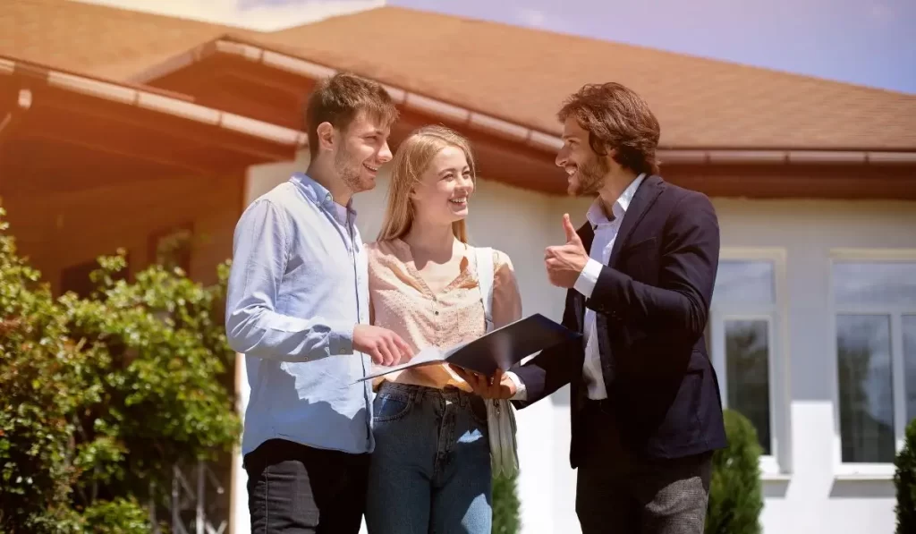Property manager screening tenants outside California rental property in sunlight.