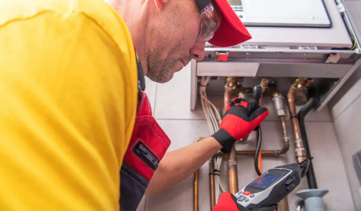 Property Management Trends illustrated by a licensed technician inspecting HVAC and plumbing systems for rental property energy compliance.